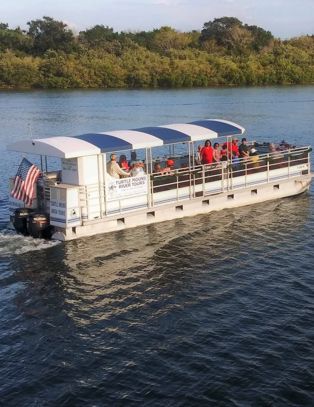 A boat with people on it in the water.