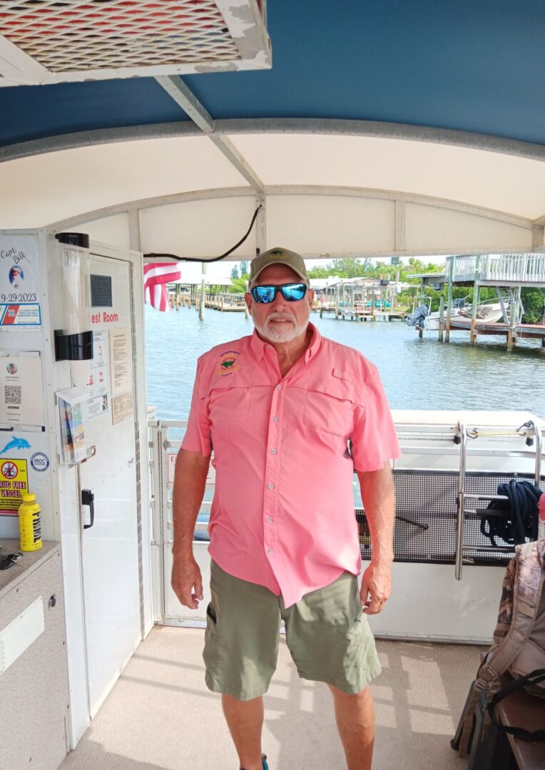 A man standing on the deck of a boat.