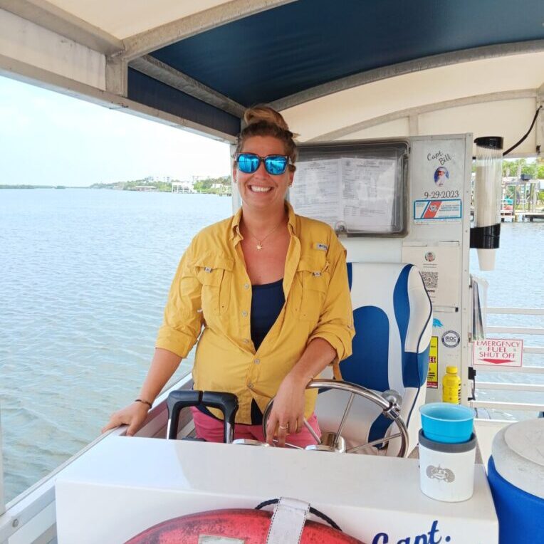 A woman sitting on the back of a boat.